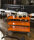 Farbiger Wagen mit 2 B&ouml;den, 2 Ebenen, 900 x 440 mm, 250 kg Tragf&auml;higkeit, Orange , mit Bremsen